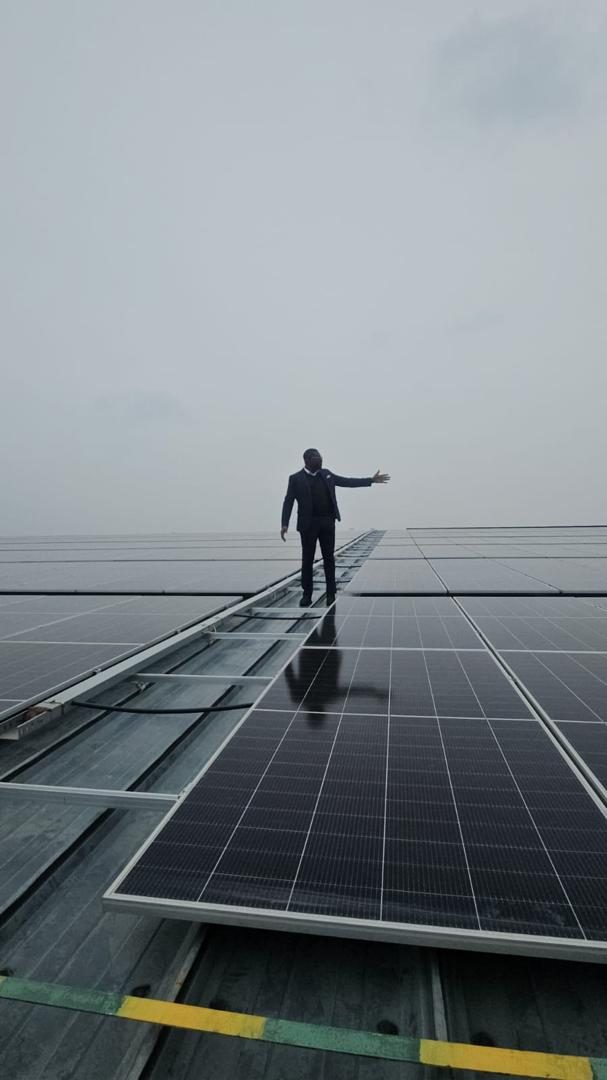 GreenApple team member on a large rooftop solar array